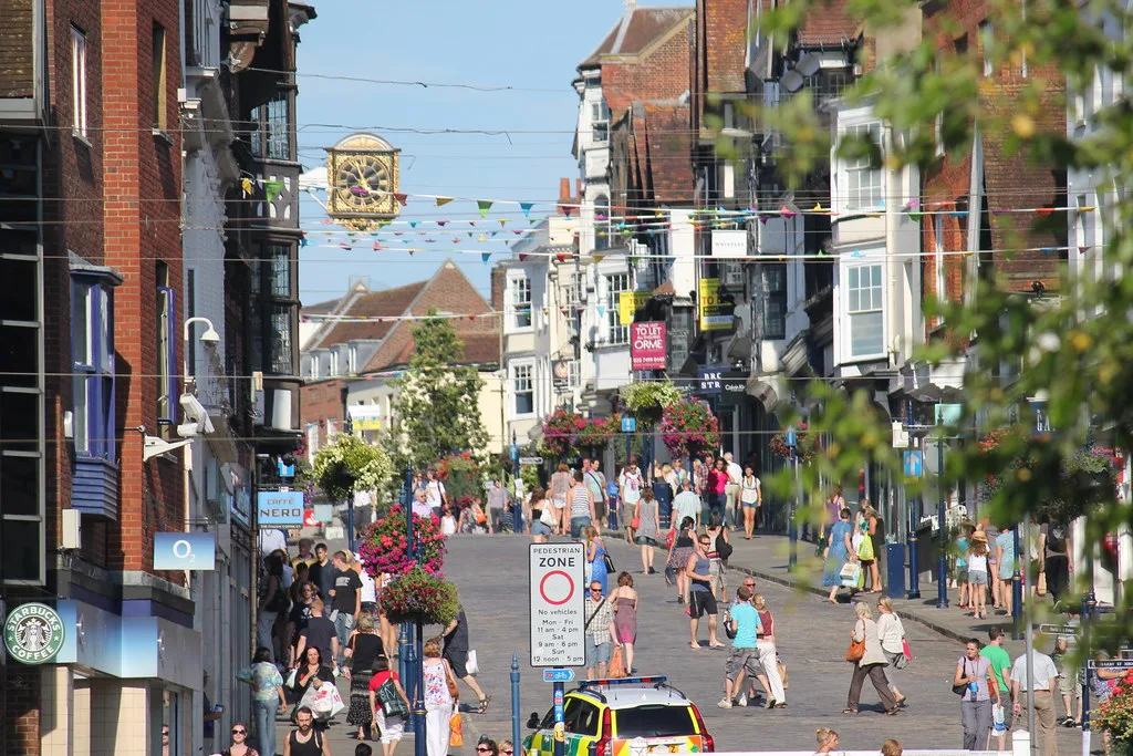 Guildford High Street, looking up towards the Guildhall clock. The picture does not show any incident in the figures.