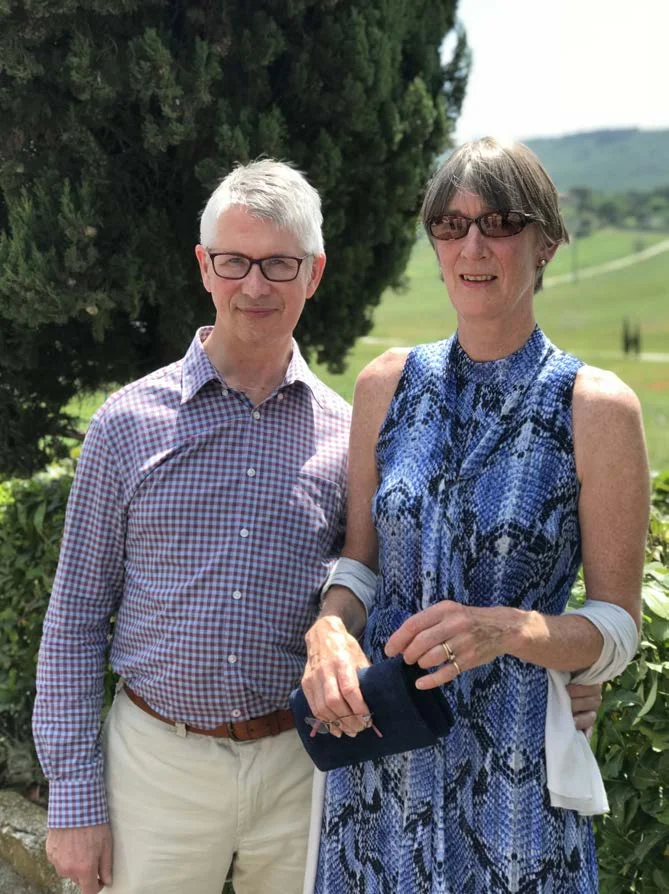 John Murphy standing beside a woman in a blue dress outdoors