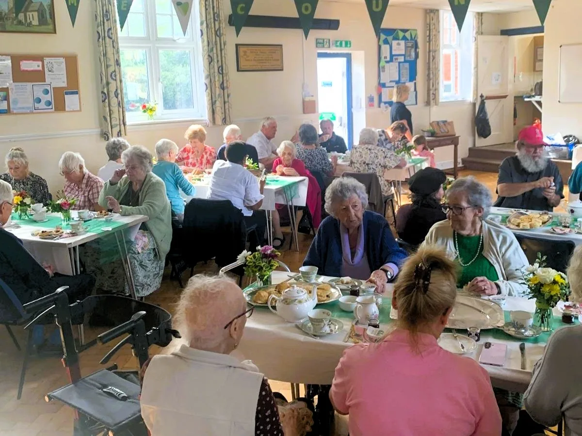 Guests at tea, cake and sandwiches at one of the two Silver Sunday vintage tea parties.